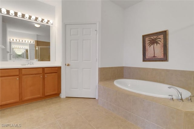 14573 Abaco Lakes Dr Unit 102, Fort Myers, FL 33908 - bathroom with a shower stall, a garden tub, vanity, and tile patterned floors