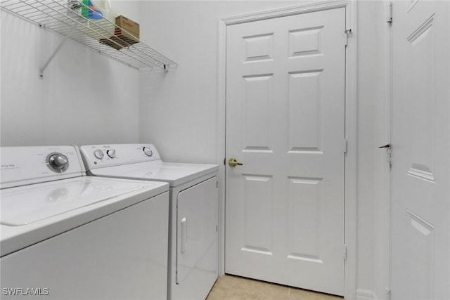 14573 Abaco Lakes Dr Unit 102, Fort Myers, FL 33908 - laundry room with washing machine and dryer and light tile patterned floors