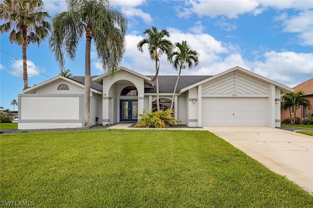 ranch-style home featuring a front yard, french doors, and a garage