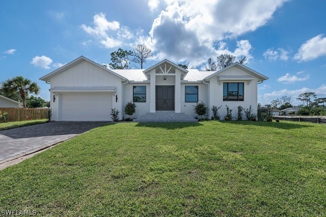 single story home with a garage and a front lawn