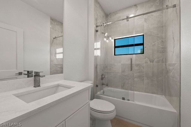 full bathroom featuring tile patterned flooring, vanity, toilet, and shower / bath combination with glass door