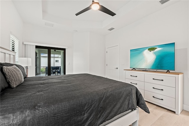 27071 Holly Ln, Bonita Springs, FL 34135 - bedroom featuring light wood-type flooring, access to exterior, visible vents, and a raised ceiling