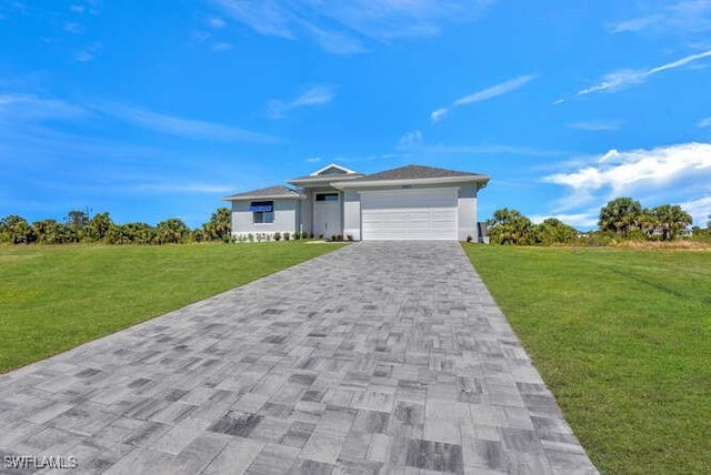 single story home featuring a garage and a front lawn