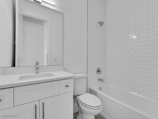 full bathroom with vanity, toilet, and tiled shower / bath combo