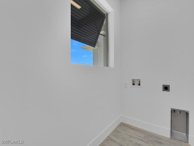 washroom featuring light wood-type flooring, hookup for a washing machine, and electric dryer hookup