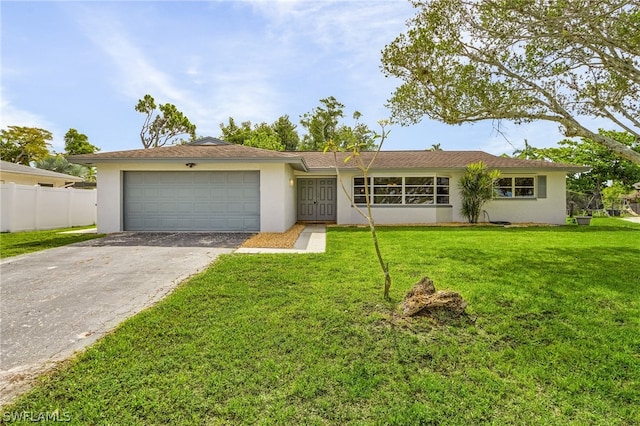 ranch-style home with a garage and a front lawn