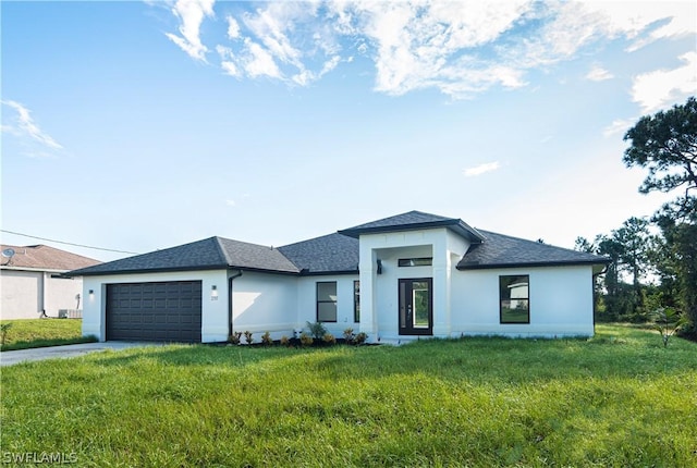 view of front of home featuring a garage and a front lawn