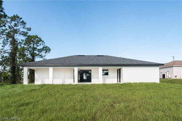 back of house featuring a yard