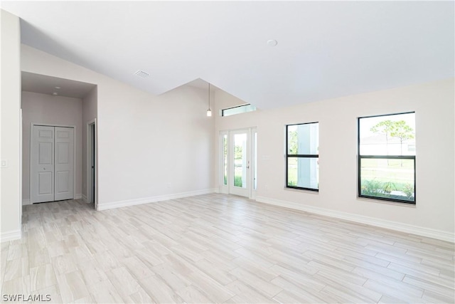 empty room featuring light hardwood / wood-style floors and lofted ceiling