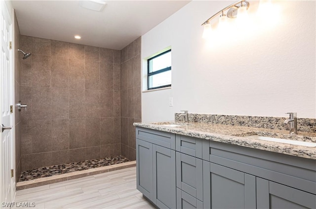 bathroom featuring vanity and tiled shower