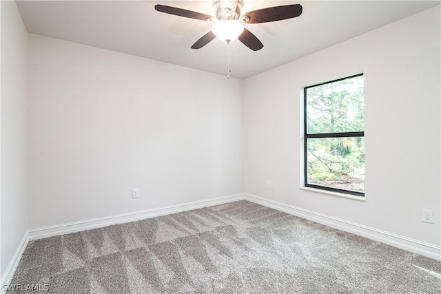 spare room featuring ceiling fan and carpet floors