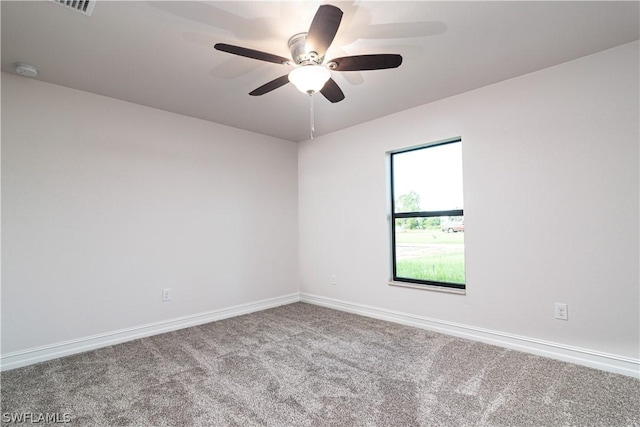 unfurnished room with ceiling fan and carpet