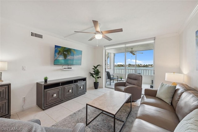 tiled living room featuring ceiling fan and ornamental molding