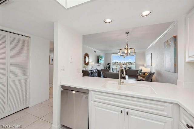 kitchen featuring white cabinets, sink, dishwasher, a chandelier, and light tile patterned flooring