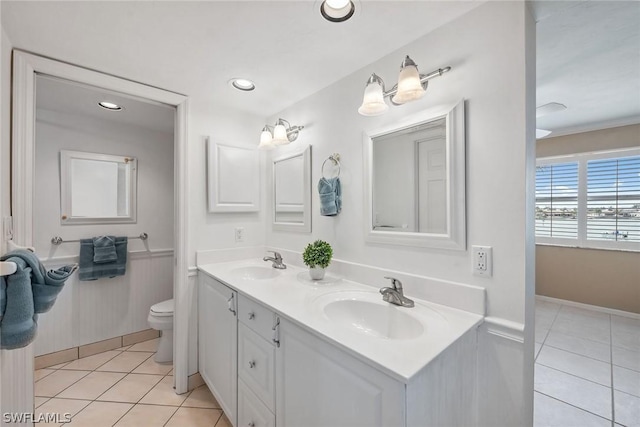 bathroom with tile patterned floors, vanity, and toilet