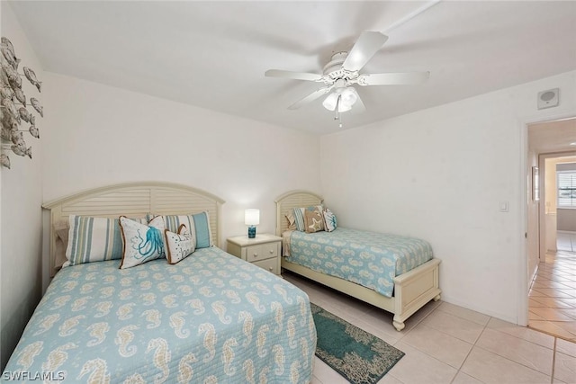 tiled bedroom featuring ceiling fan