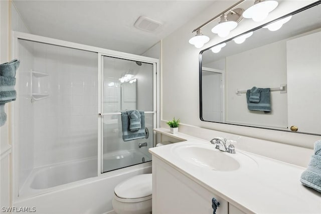 full bathroom with vanity, bath / shower combo with glass door, and toilet