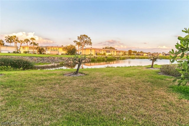 251 Palm Dr Unit 251-2, Naples, FL 34112 - view of green lawn with a water view and a residential view