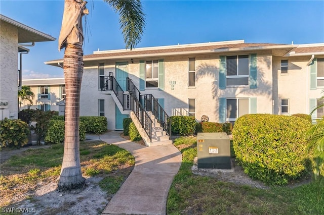 251 Palm Dr Unit 251-2, Naples, FL 34112 - view of building exterior with stairs