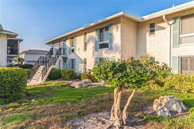 251 Palm Dr Unit 251-2, Naples, FL 34112 - exterior space featuring stucco siding and stairway