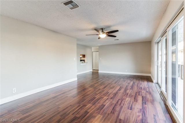 251 Palm Dr Unit 251-2, Naples, FL 34112 - empty room with ceiling fan, a textured ceiling, dark wood-style flooring, and baseboards