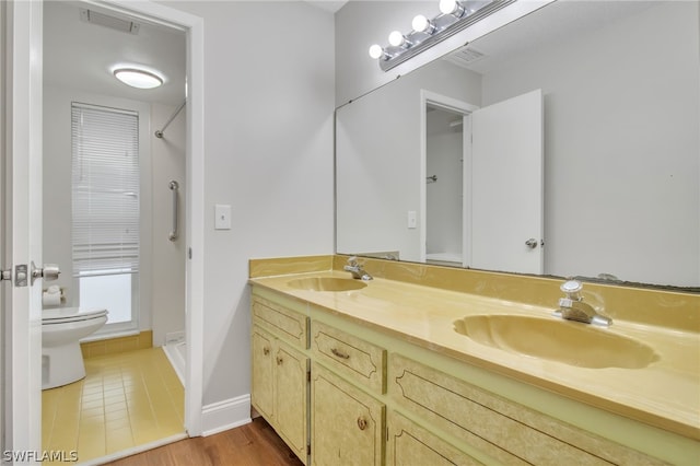 251 Palm Dr Unit 251-2, Naples, FL 34112 - bathroom with toilet, double vanity, a shower, and baseboards