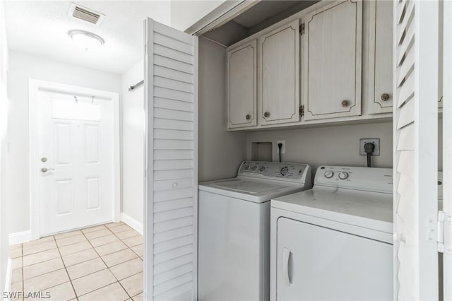251 Palm Dr Unit 251-2, Naples, FL 34112 - laundry area featuring cabinet space, independent washer and dryer, light tile patterned floors, and baseboards