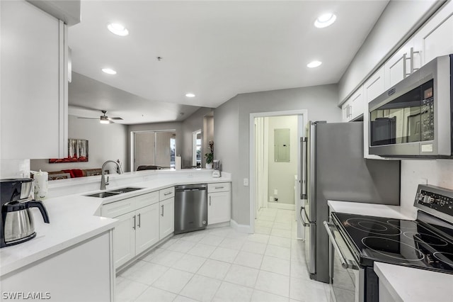 kitchen featuring white cabinets, sink, ceiling fan, appliances with stainless steel finishes, and kitchen peninsula