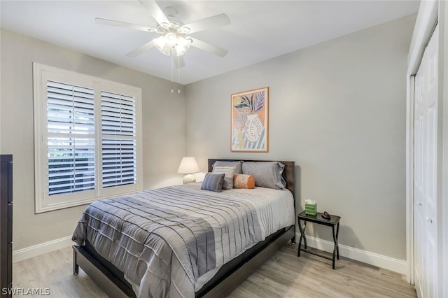 bedroom featuring light wood-type flooring, a closet, and ceiling fan