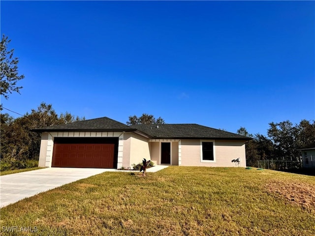 view of front of property featuring a front yard and a garage