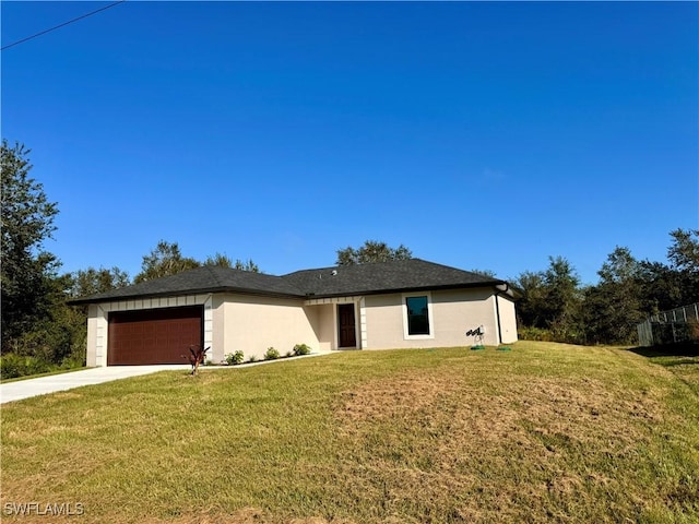 view of front of property featuring a garage and a front lawn