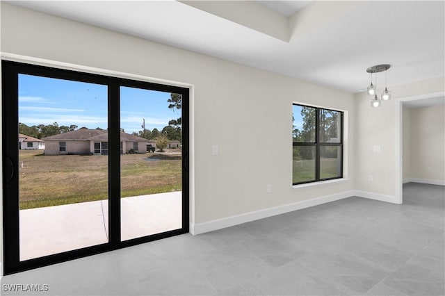 unfurnished room featuring baseboards and tile patterned flooring