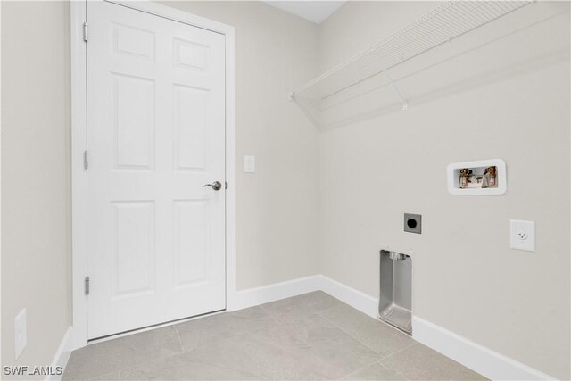 laundry area with electric dryer hookup, hookup for a washing machine, and baseboards