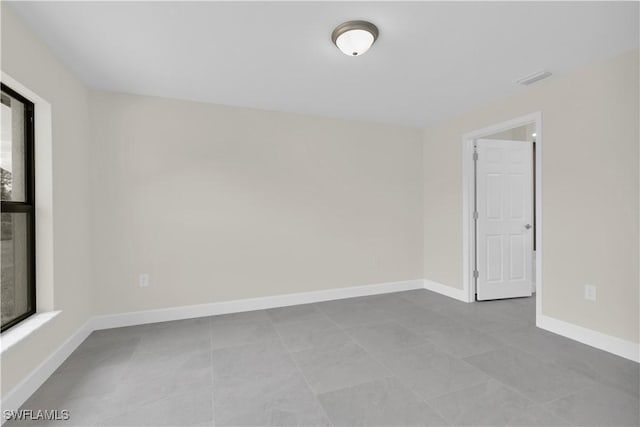 spare room featuring baseboards