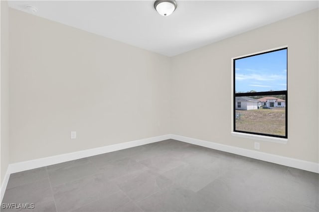 unfurnished room featuring baseboards
