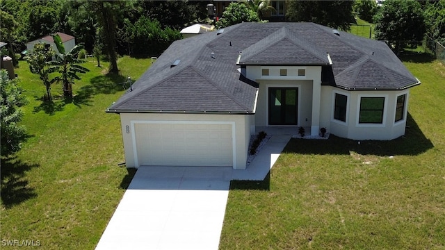 view of front of house with a front yard and a garage