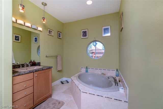 bathroom featuring tile patterned flooring, vanity, and a relaxing tiled tub