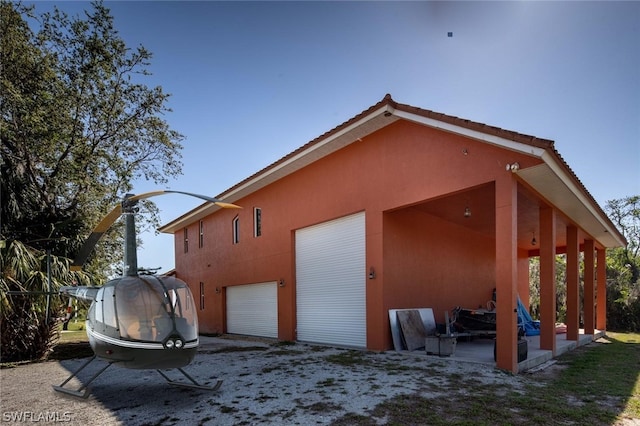 rear view of property featuring a garage