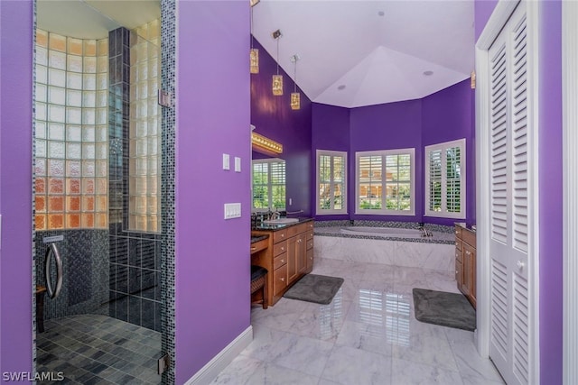 bathroom with shower with separate bathtub, vanity, and lofted ceiling