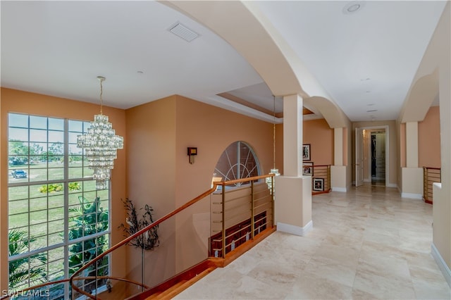 hallway featuring an inviting chandelier