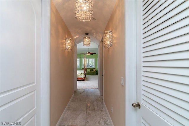 corridor with an inviting chandelier