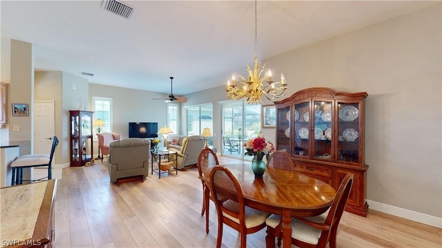 dining room featuring ceiling fan with notable chandelier and light wood-type flooring