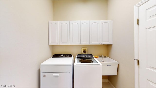 laundry room with cabinets and separate washer and dryer