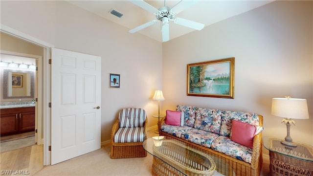 sitting room featuring light carpet and ceiling fan