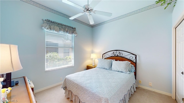 bedroom featuring a closet, crown molding, ceiling fan, and light colored carpet