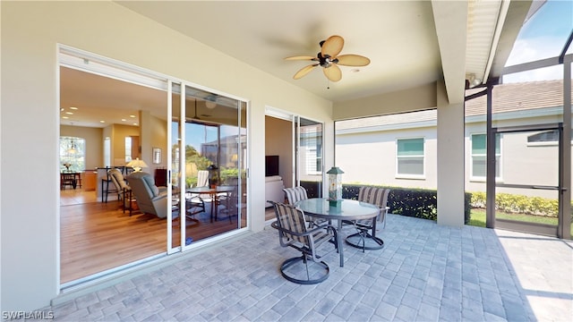 sunroom / solarium featuring ceiling fan