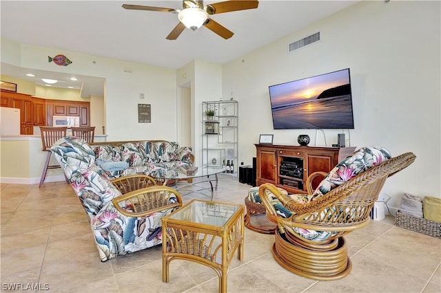 living area featuring visible vents, ceiling fan, and light tile patterned floors