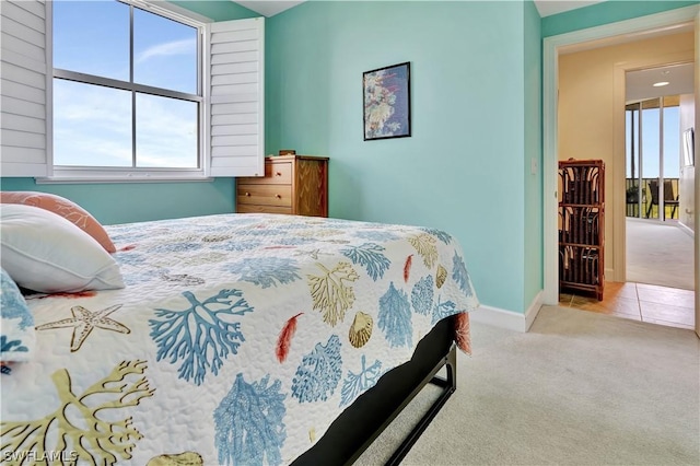 carpeted bedroom featuring baseboards and tile patterned floors