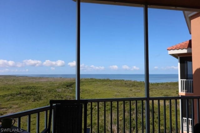 unfurnished sunroom with a water view