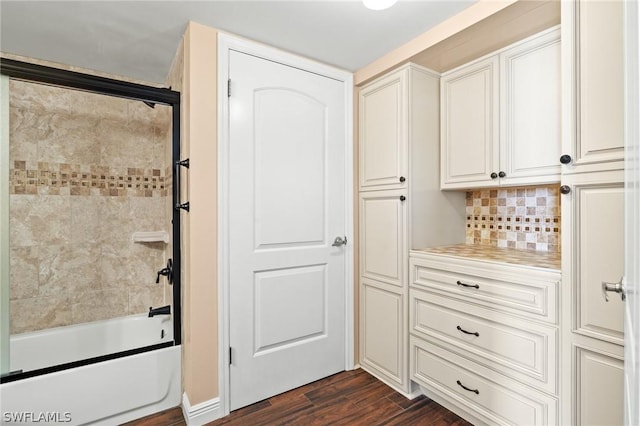 interior space featuring dark hardwood / wood-style flooring and tasteful backsplash